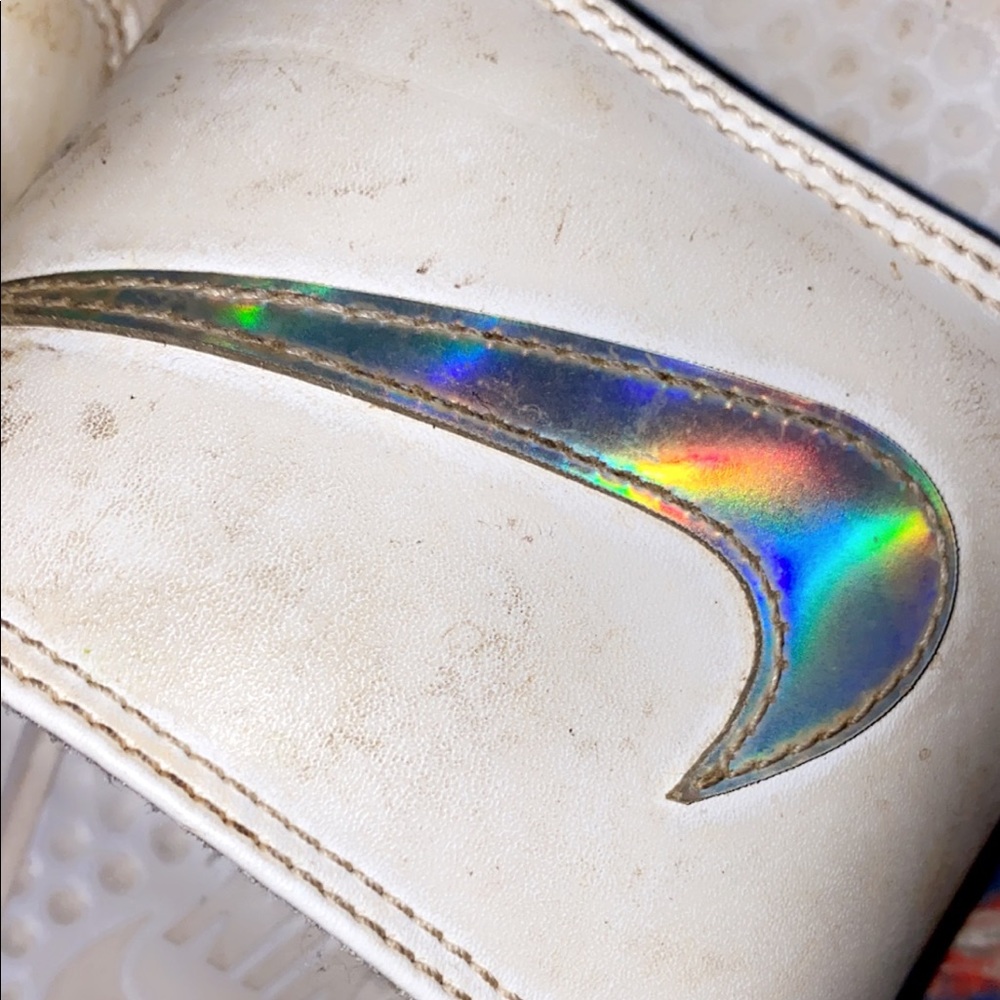 white and holographic nike slides